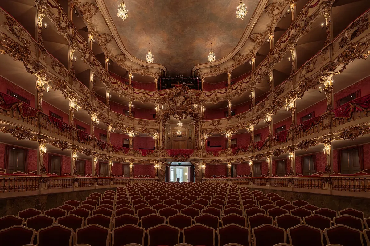 The red and gold Cuvilliés Theatre in the Residenz, with tiers of carved gilded boxes around the stalls.