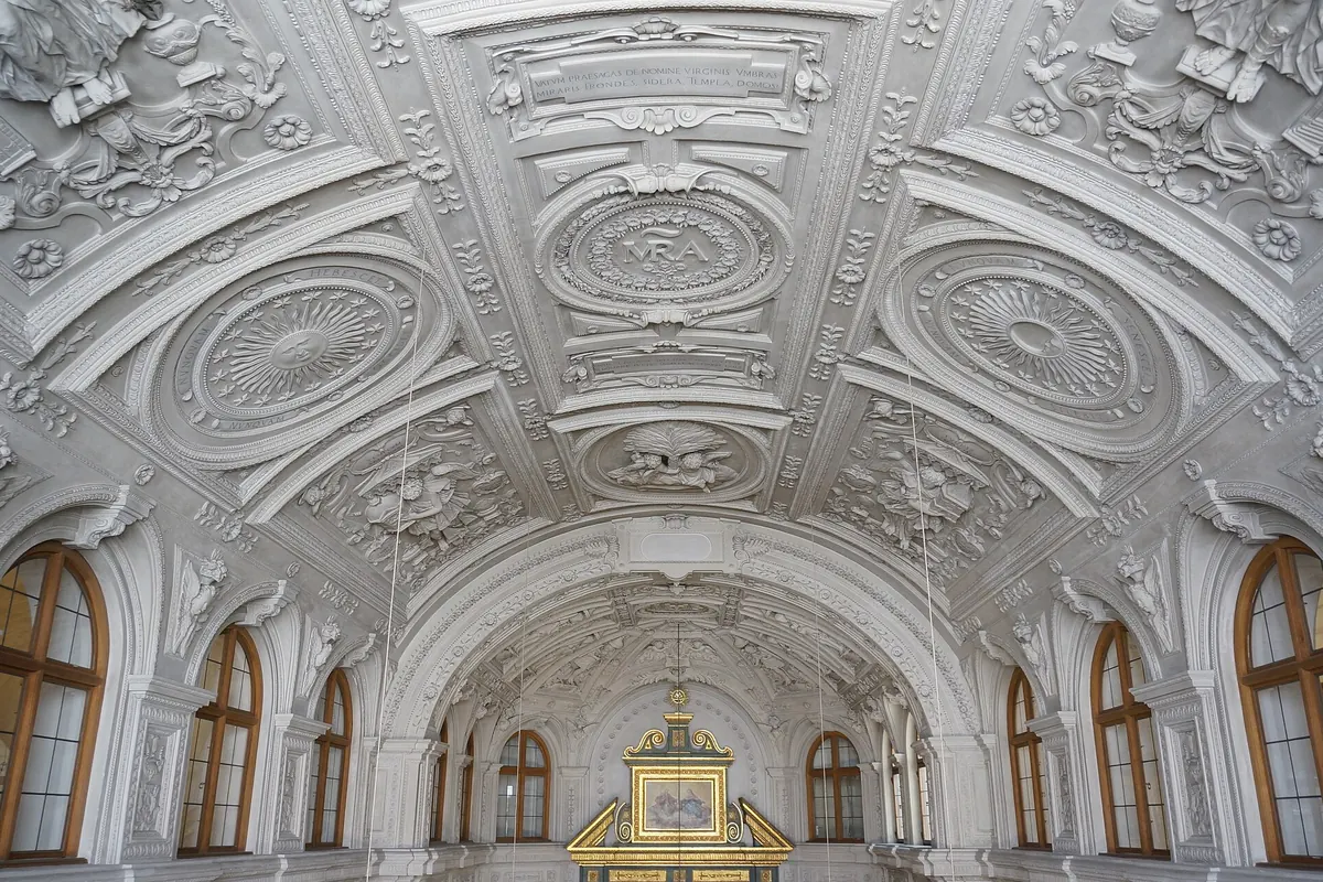 The vault of the Residenz court chapel covered in white stucco ribs, medallions and relief ornament